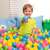 Child playing in a ball pit with Bestway 6.5cm colorful plastic balls