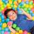 Child playing in a ball pit with Bestway 6.5cm colorful plastic balls