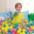 Child playing in a ball pit with Bestway 6.5cm colorful plastic balls