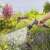 Gardena Comfort Cleaning Spray Nozzle ecoPulse, grey-orange, in use, watering flowers
