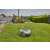 Gardena SILENO life 1250 robot lawnmower, mowing the lawn, man relaxing in the background