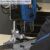 Close-up of Scheppach DP 60 drill press in use with quick-release clamp