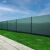 Springos green shade net installed on a fence for privacy