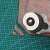 Rotary cutter for fabric and paper, used on a green cutting mat