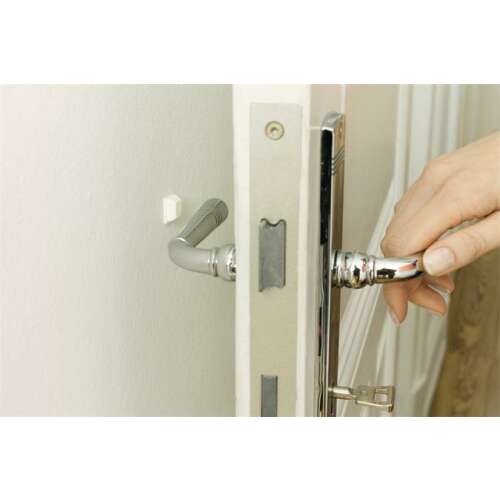 Tesa Protect door bumper, white, 10x10mm, installed on a door to prevent damage from the handle