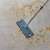Bewello Easy Squeeze Mop with microfiber pad cleaning a floor with stains