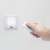 Hand holding remote control for LED wall lamp