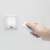 Hand holding remote control for LED wall lamp