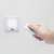 Hand holding remote control for LED wall lamp
