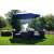 Funfit premium tilting garden parasol with steel frame and crank, 3.5m, dark blue, in a garden setting with furniture