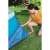 Woman placing Bestway pool ground cloth under inflatable pool