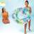 Girl holding Intex 97 cm inflatable ring with tropical leaves design