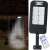 Solar powered motion sensor wall light with remote control illuminating a doorway