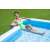 Bestway inflatable pool with a person sitting on the edge, enjoying a drink