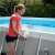 Woman installing Intex magnetic LED pool light on above ground pool