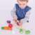 Child playing with wooden toy vegetable set, learning about healthy eating and kitchen skills