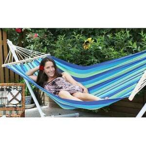 Pamutkerti 200x100 cm cotton hammock in blue and green stripes, with a person relaxing in it - Garden