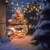 Solar powered LED string lights with warm white bulbs, decorating a Christmas tree in a snowy winter setting.
