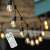 Solar powered LED string lights with warm white bulbs, showcasing their remote control functionality.