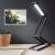 Kwmobile foldable LED desk lamp in black, with touch control and 3 brightness settings, in use on a desk