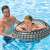 Man helping child using INTEX 91cm Hi Performance inflatable swim ring, black and grey tire design
