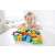Child playing with Hape String-Along Shapes wooden toy, stringing colorful blocks together