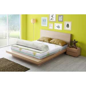 Eucalyptus Comfort 7 zone mattress topper on a bed, rolled up - Blanket mattress