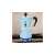 Bialetti Rainbow 3-cup light blue stovetop espresso maker in use on a gas stove