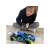 Boy playing with Exost RC Xmoke remote control car, blue and black with yellow accents, 1:14 scale