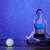 NiteBird LB4 Smart LED Starry Sky Projector, projecting starry sky on a wall, woman doing yoga