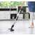 Woman using Trisa 94974610 cordless wet and dry floor cleaner
