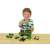 Child playing with John Deere tractor with front loader and weight, 1:24 scale, green and yellow toy tractor