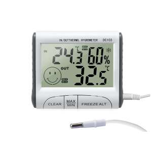 Cyfrowy termometr higrometr wewnętrzny i zewnętrzny z wyświetlaczem LCD, pokazujący temperaturę i wilgotność, z ikoną uśmiechniętej twarzy - Verk Group