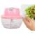 Electric food chopper, pink, being used to chop salad