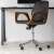 Black leather office chair with wooden arms and chrome base on wheels
