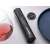 Electric wine opener on a table with a wine glass and a plate