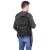 Springos black tactical backpack worn by a man, rear view
