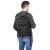 Springos black tactical backpack worn by a man, rear view