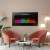 Black electric fireplace with colorful LED flames in a living room setting