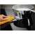Electrolux LIB60420CK induction hob easy to clean, shown with a hand wiping a spill