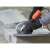 Black & Decker BEG220K-QS angle grinder in use, cutting stone
