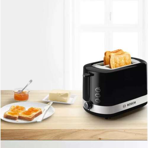 Bosch TAT6A513 2-slice toaster, black with stainless steel accents, showing toasted bread