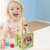 Toddler playing with the wooden activity cube, 5 in 1 toy for toddlers