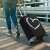 Woman using Kwmobile suitcase cover with white heart design, L size, for 25-28 inch suitcases