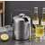 Stainless steel ice bucket with lid, ice tongs, spoon, and strainer