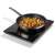 Gorenje ICY2000SP single induction hob in use, black, cooking stir-fry in a pan