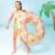 Girl using Intex 114cm patterned inflatable swim ring, pink and orange design