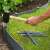 Installing gray plastic garden edging stakes
