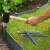 Installing gray plastic garden edging stakes