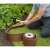 Nature brown garden edging installed, curved shape, with roll and tools, person installing